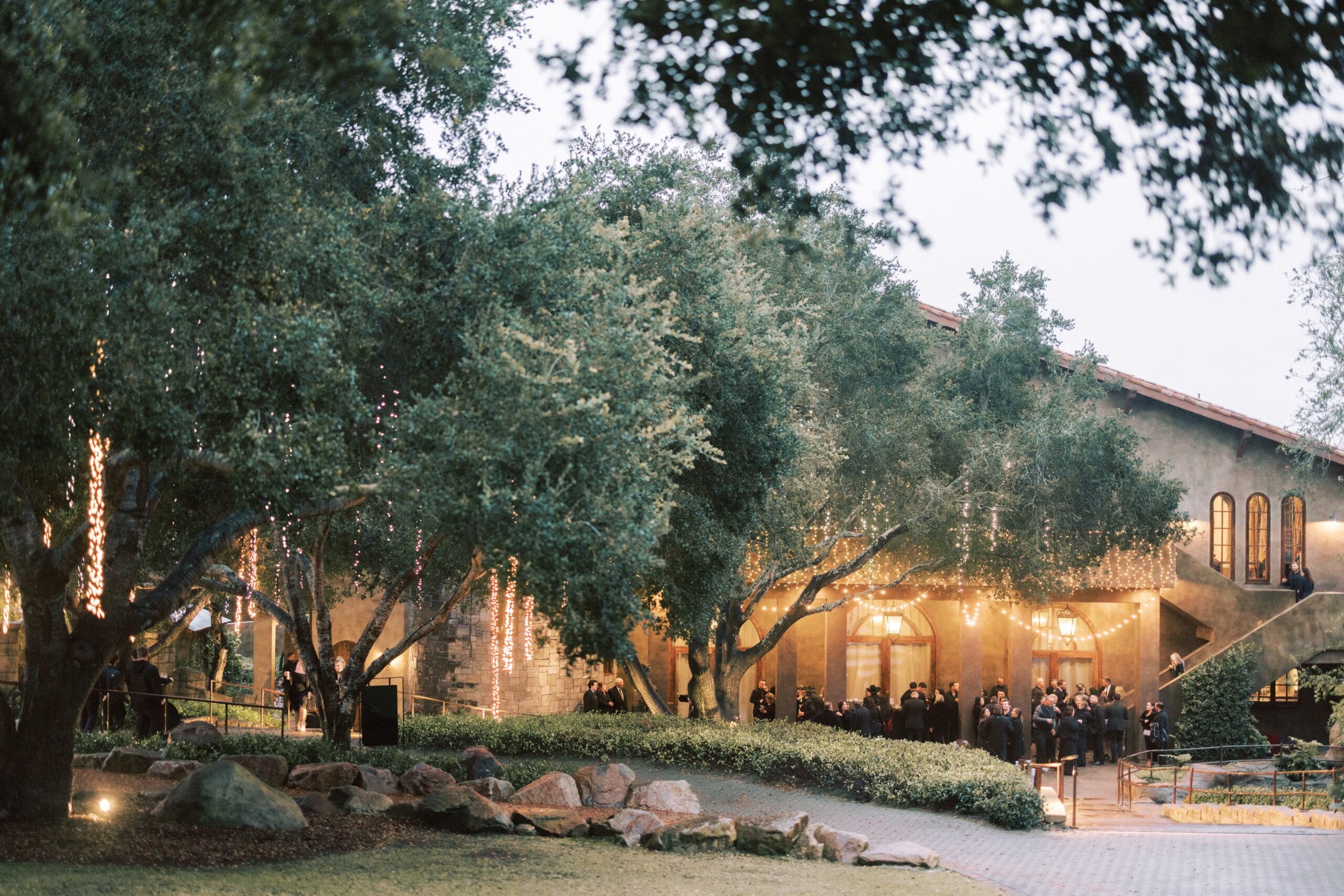 Park lawn shaded by oak trees at Villa Loriana for a company retreat